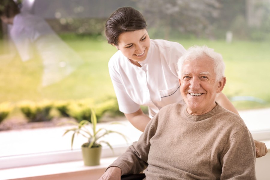 photo of a elderly man and a carer